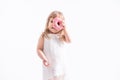 Funny child girl in white dress with pink donut on white background Royalty Free Stock Photo