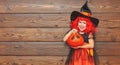 Funny child girl in witch costume for Halloween with pumpkin Ja Royalty Free Stock Photo