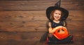 Funny child girl in witch costume for Halloween with pumpkin Ja Royalty Free Stock Photo