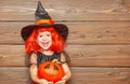 Funny child girl in witch costume for Halloween with pumpkin Ja Royalty Free Stock Photo