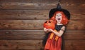 Funny child girl in witch costume for Halloween with pumpkin Ja Royalty Free Stock Photo