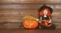 Funny child girl in witch costume for Halloween with pumpkin Ja Royalty Free Stock Photo