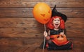 Funny child girl in witch costume for Halloween with pumpkin Ja Royalty Free Stock Photo