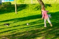 Funny child in glasses playing in a summer park.