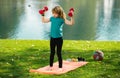 Funny child lifting the dumbbells in backyard outside. Kids in training.