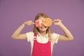 Funny child with lollipops on violet background. Girl smiling with candy eyes. Little kid smile with candies on sticks Royalty Free Stock Photo