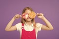 Funny child with lollipops on violet background. Little kid smile with candies on sticks on purple background. Girl