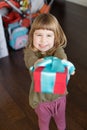 Funny child offering present box in hands