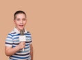 Funny Child Performs. Boy Sings A Song Into The Microphone.
