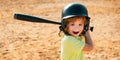 Funny child playing Baseball. Batter in youth league getting a hit. Boy kid hitting a baseball. Royalty Free Stock Photo