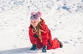 Funny child playing with snow in winter. Little girl in colorful jacket and knitted. Kids play in snowy forest. Children