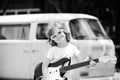 Funny child with rock guitar. American country boy playing music. Royalty Free Stock Photo