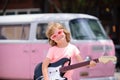 Funny child with rock guitar. American country boy playing music. Royalty Free Stock Photo