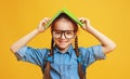 Funny child school girl girl on yellow background Royalty Free Stock Photo