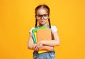 Funny child school girl girl on yellow background Royalty Free Stock Photo