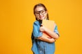 Funny child school girl girl on yellow background