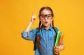 Funny child school girl girl on yellow background Royalty Free Stock Photo