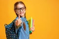Funny child school girl girl on yellow background Royalty Free Stock Photo