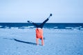 Funny child teenager girl in red sweater doing cartwheel. Excited teenage kid playing on beach. Happy lifestyle childhood concept Royalty Free Stock Photo