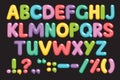 Funny children font with color letters. Colorful alphabet on a black background. Royalty Free Stock Photo