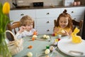 Funny children getting ready for Easter holiday. Boy and girl paint eggs. Happy easter. Royalty Free Stock Photo