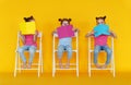 Funny children girls read books on colored yellow background