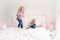 Funny children jumping on bed in bedroom Royalty Free Stock Photo