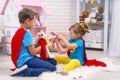 Funny children play with toys in the superheroes, in the children room Royalty Free Stock Photo