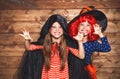 Funny children sister twins girl in witch costume in halloween Royalty Free Stock Photo