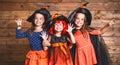 Funny children sister twins girl in witch costume in halloween