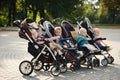 Funny children sitting in strollers in park Royalty Free Stock Photo