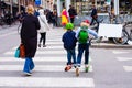 Funny children skate on the scooters at the crossroads