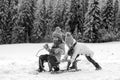 Funny children in snow ride on sled. Winter outdoors games. Happy Christmas family vacation concept. Kids enjoy the Royalty Free Stock Photo