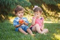 Funny children toddlers sitting together sharing apple food Royalty Free Stock Photo