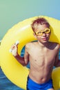 Funny chilld with swimmer goggles standing on beach Royalty Free Stock Photo