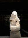 A funny Chinese stone lion standing on a stone pillar