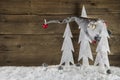 Funny christmas background of wood with snow and a santa hanging