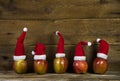 Funny christmas greeting card with five red santa hats on apples Royalty Free Stock Photo