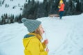 Funny christmas kids lick snow icicle with tongue. Kids cold and flu concept. Children wearing warm winter clothing in