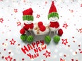 Funny christmas and new year decorative composition. Side view, background with copy space. Two Christmas snowmen holding gift, Royalty Free Stock Photo