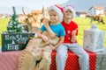 Funny Christmas pose by two children and cow