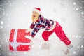 Funny Christmas woman and a big gift box. Funny woman holding a big Christmas present. Crazy Christmas girl pushes a big Royalty Free Stock Photo