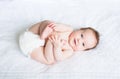 Funny chubby baby playing with its feet Royalty Free Stock Photo