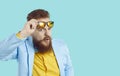 Funny chubby bearded man looks at you with expression of suspicion, doubt and disbelief on his face. Royalty Free Stock Photo