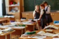 Funny classmates. Three cute little children communicate and discuss something standing near the blackboard . Background image