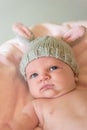 Closeup of a newborn baby in a knit bunny ear hat