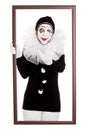 Funny clown in a frame stretches out hand Royalty Free Stock Photo