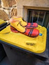 Funny clown shoes on the yellow garbage can Royalty Free Stock Photo