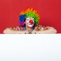 Funny clown with tie on blank board Royalty Free Stock Photo