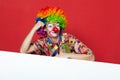Funny clown with tie on blank board Royalty Free Stock Photo